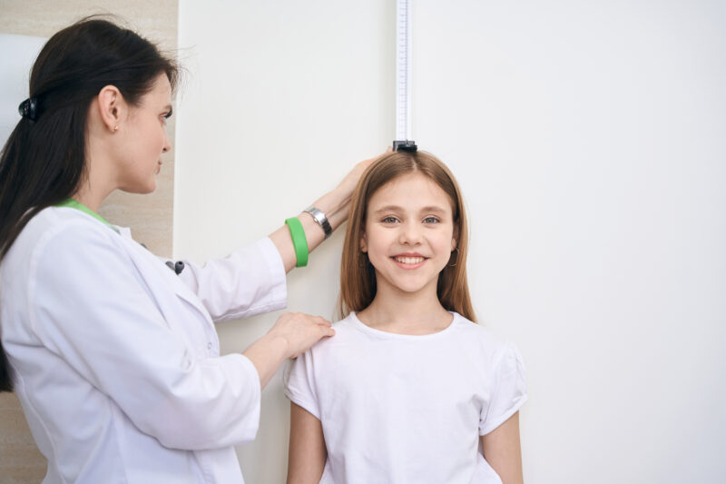 school nurse checking child's height